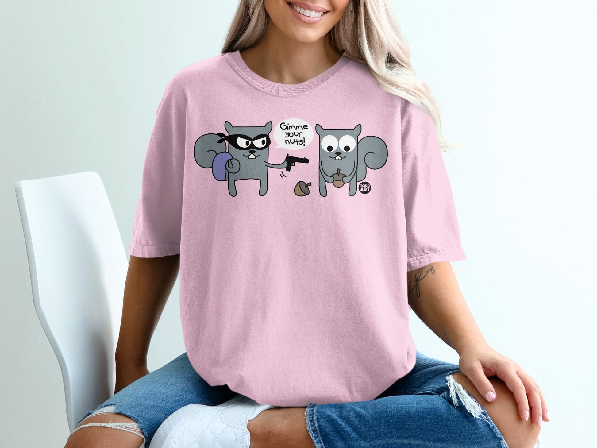 T-shirt with cartoon robber squirrel demanding nuts from another squirrel.