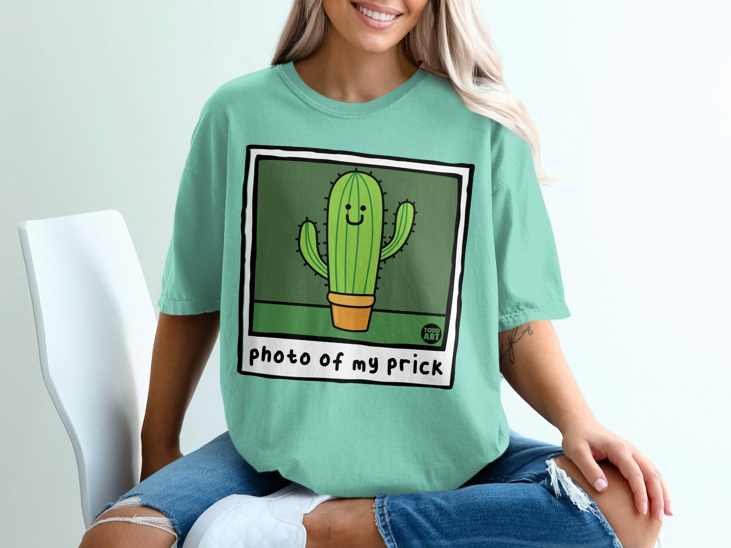 Teal t-shirt with cartoon cactus graphic and "photo of my prick" text.