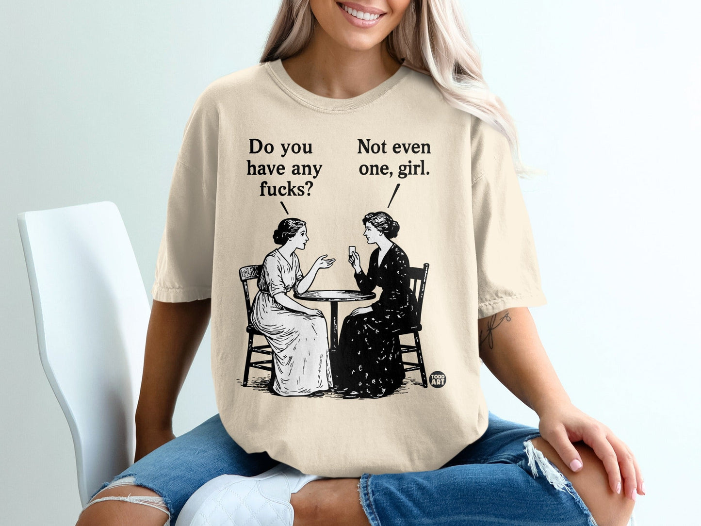 T-shirt featuring a black and white illustration of two women at a table.