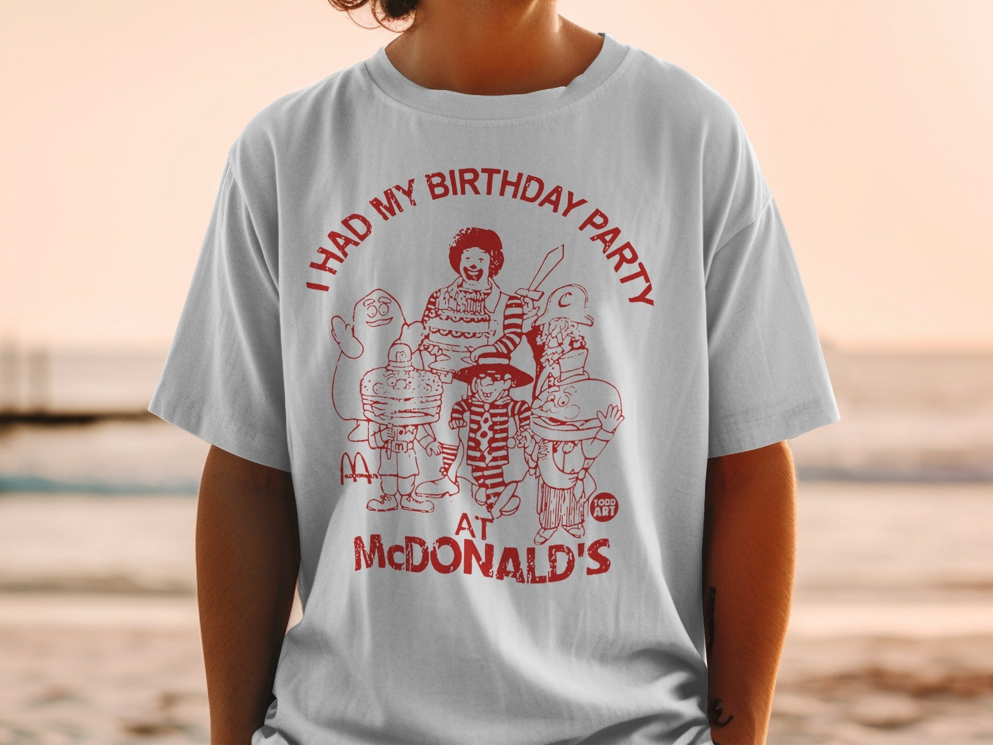 McDonald's birthday party graphic tee with cartoon characters and text.