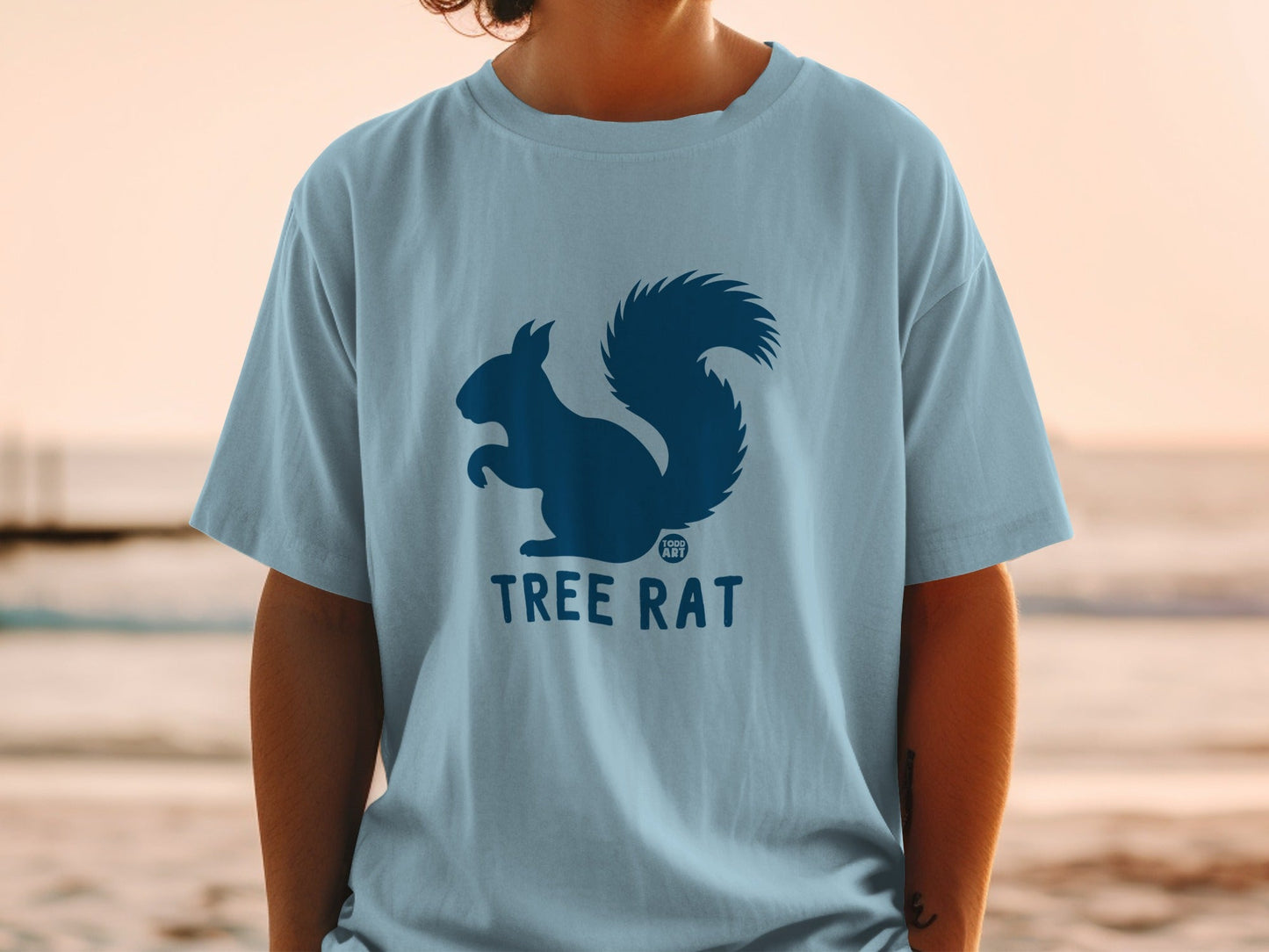Light blue t-shirt with dark blue squirrel and "TREE RAT" logo.