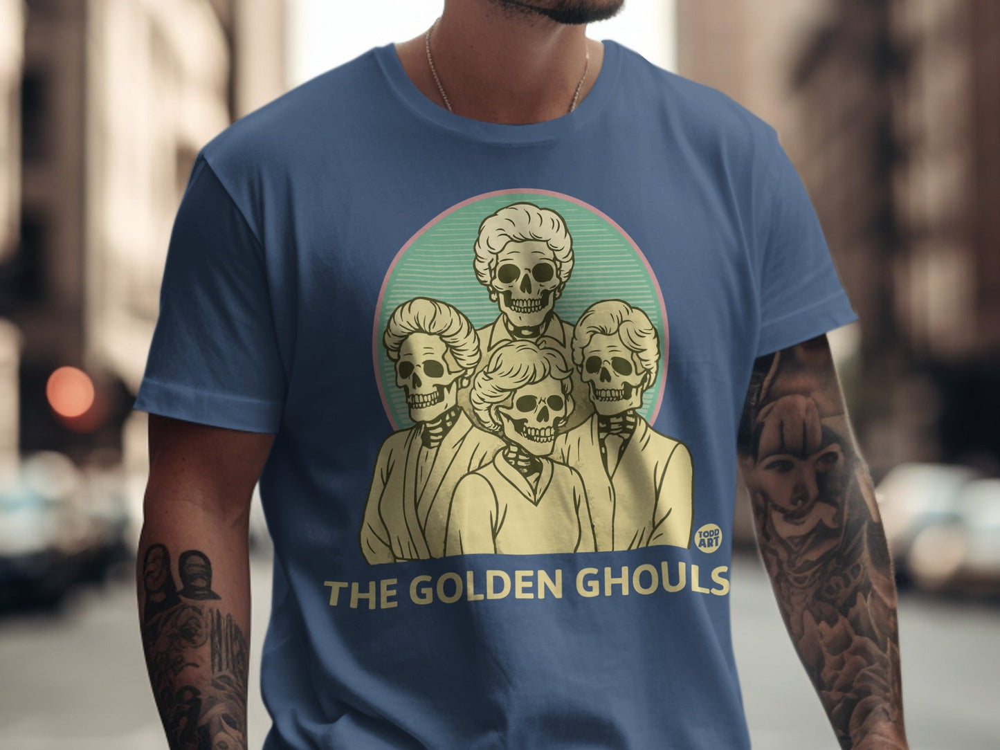 The Golden Ghouls t-shirt design features four stylized skeleton heads.