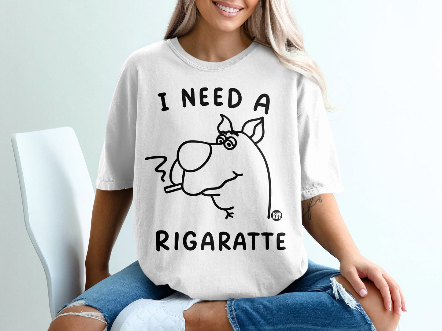 White t-shirt with "I NEED A RIGARETTE" and cartoon dog smoking.