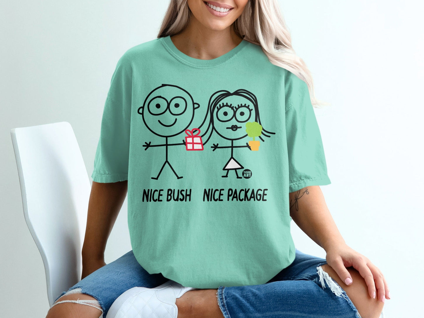 Mint t-shirt with stick figures, gift, and text "NICE BUSH NICE PACKAGE".