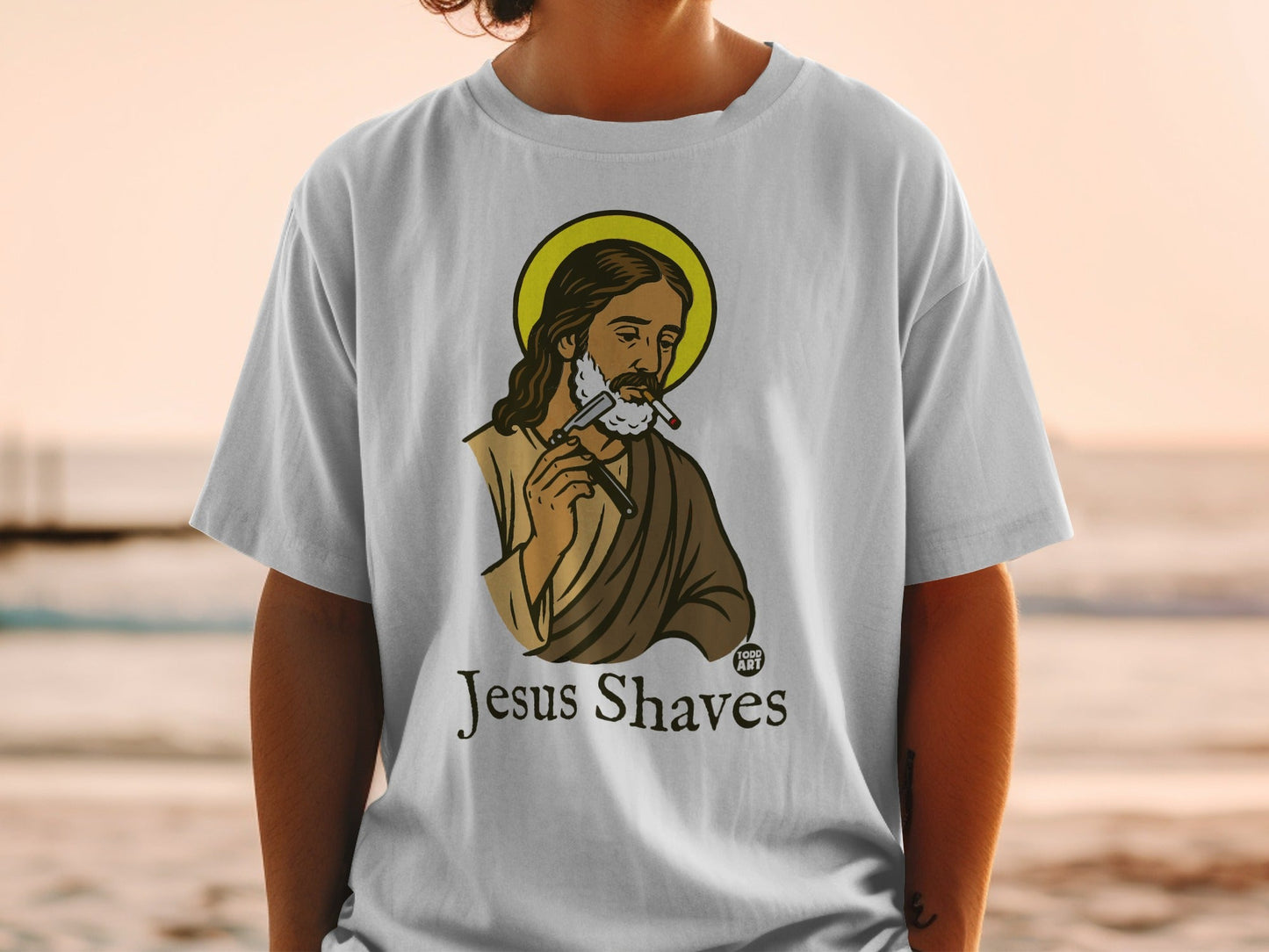 T-shirt with a graphic of Jesus shaving with a cigarette in his mouth.
