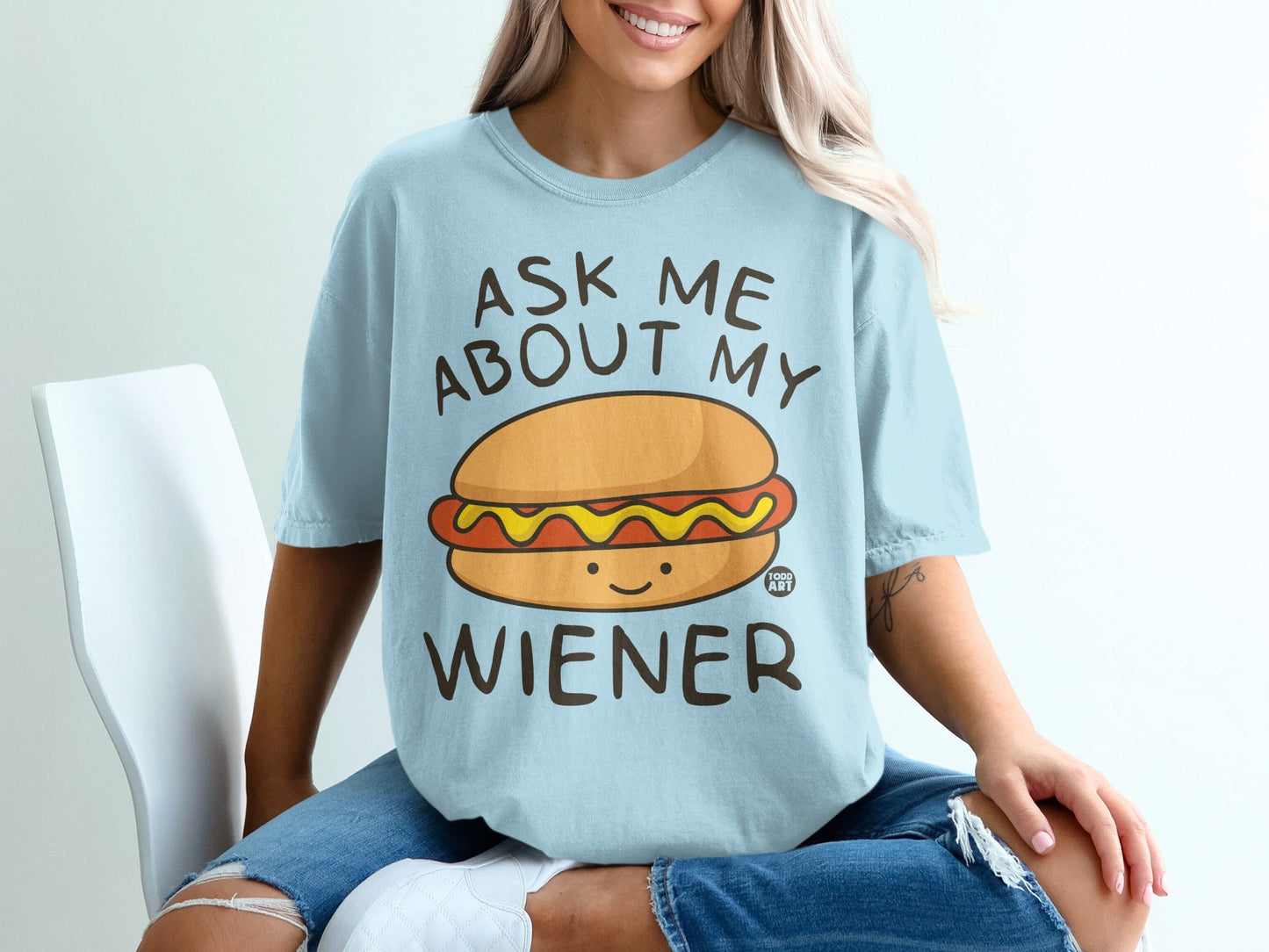 Light blue t-shirt with "ASK ME ABOUT MY WIENER" and a smiling cartoon hot dog.