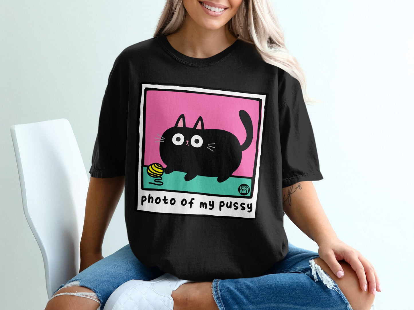 Black t-shirt with cartoon cat and yarn graphic, text "photo of my pussy".