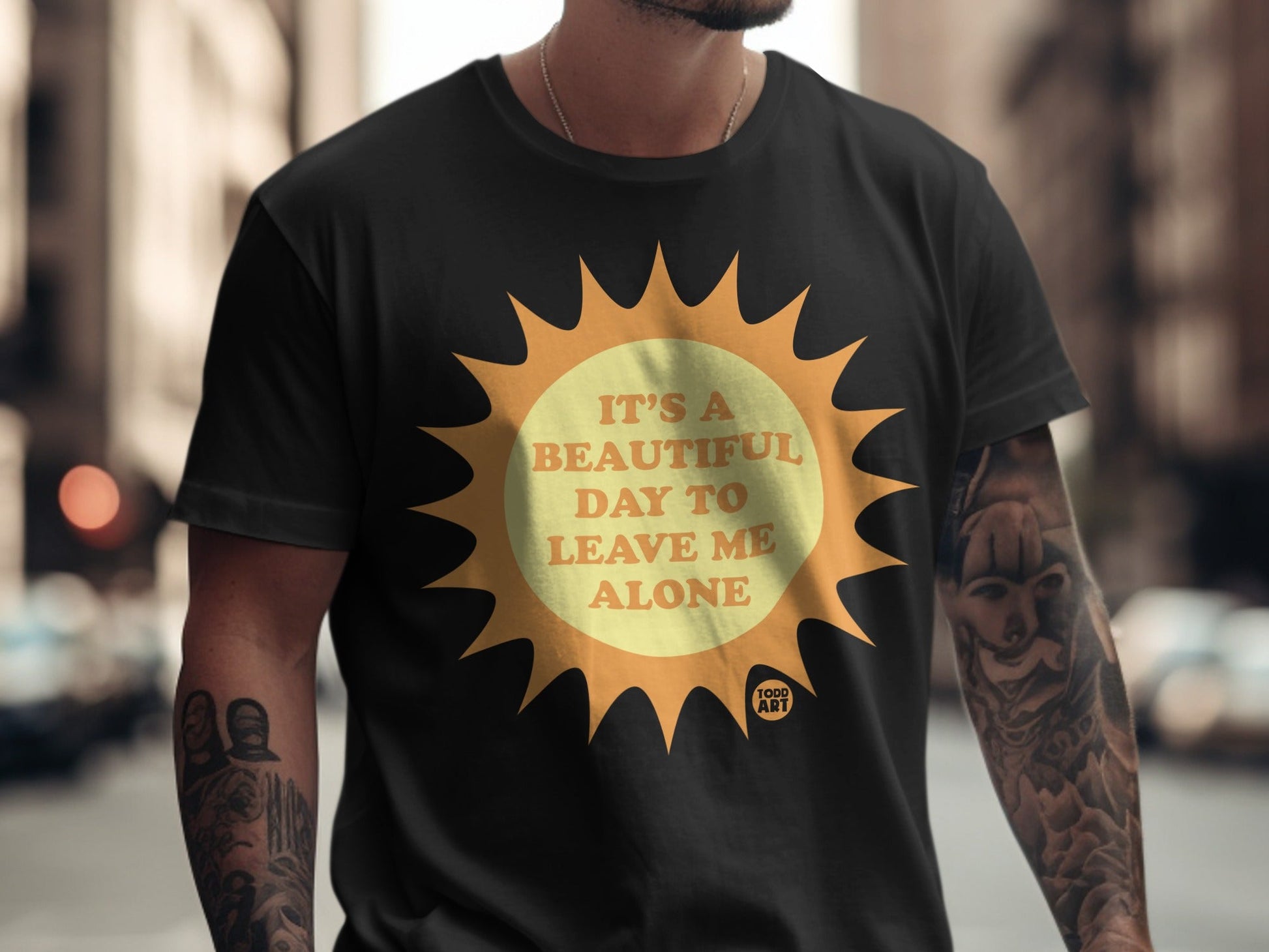 Black t-shirt with orange sun graphic and text "It's a beautiful day to leave me alone."