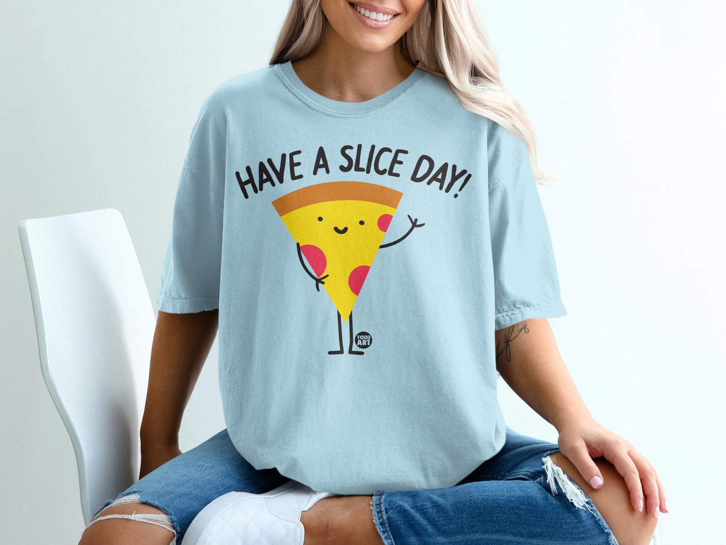 Light blue t-shirt with a smiling pizza slice saying "Have a Slice Day!"