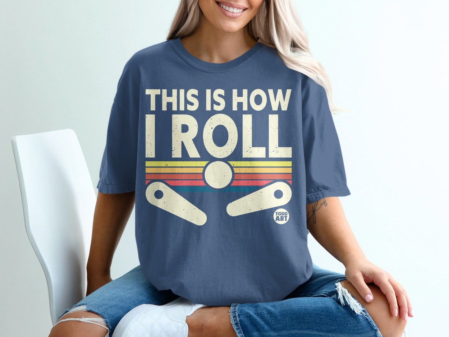 Blue t-shirt with "THIS IS HOW I ROLL" and pinball graphic.