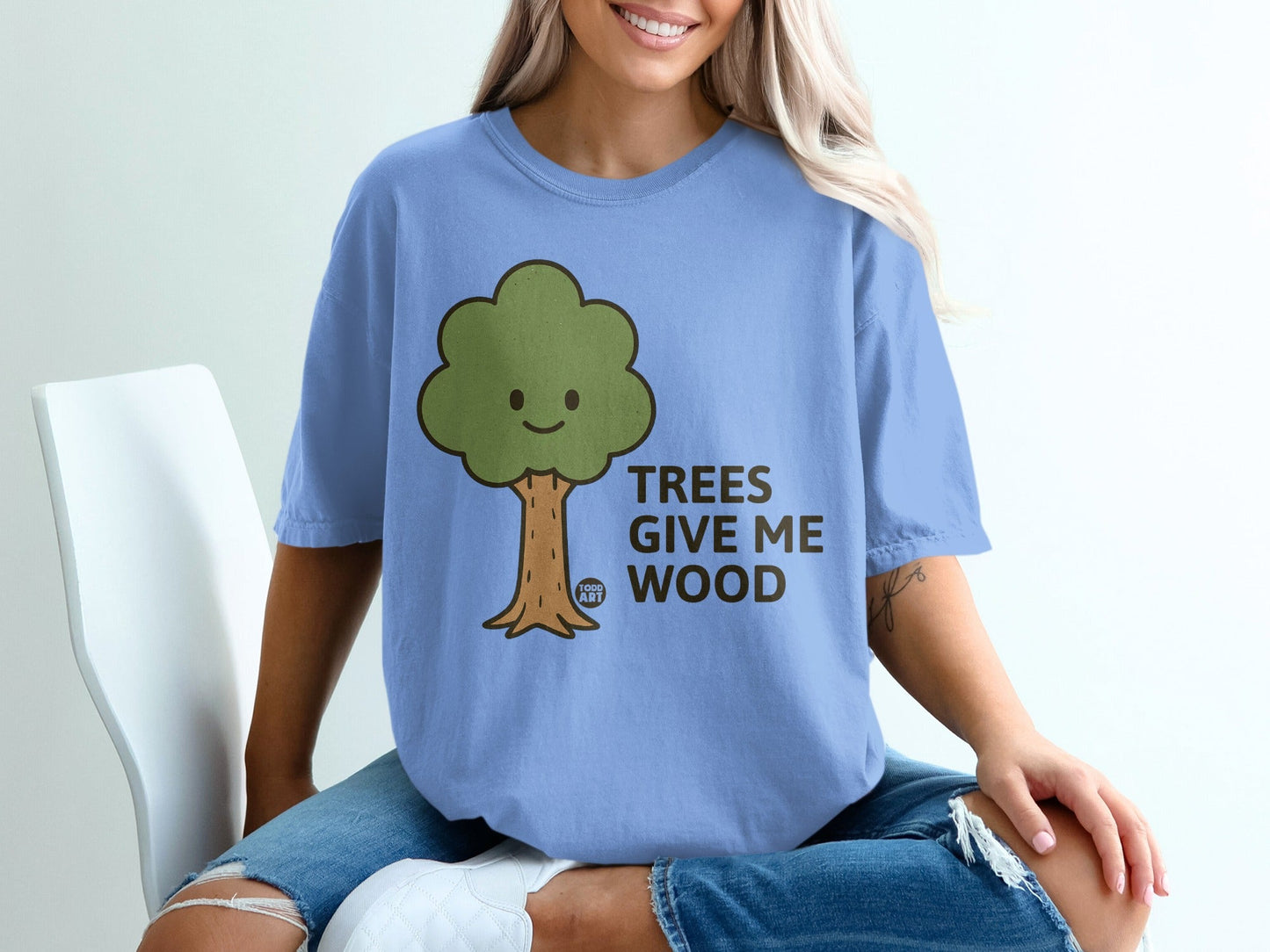 Light blue t-shirt with "TREES GIVE ME WOOD" and a smiling tree design.
