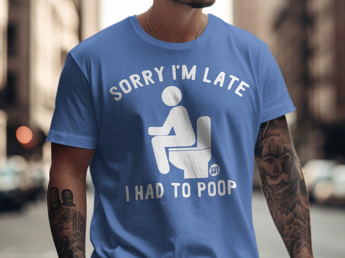 Blue t-shirt with "SORRY I'M LATE I HAD TO POOP" graphic.