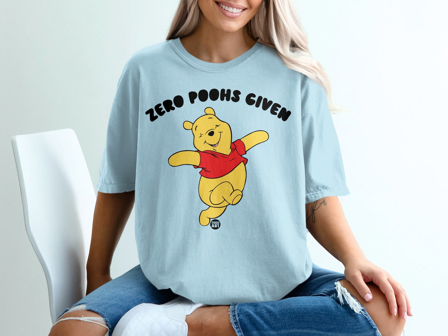 Light blue t-shirt with Winnie the Pooh and "ZERO POOHS GIVEN" text.