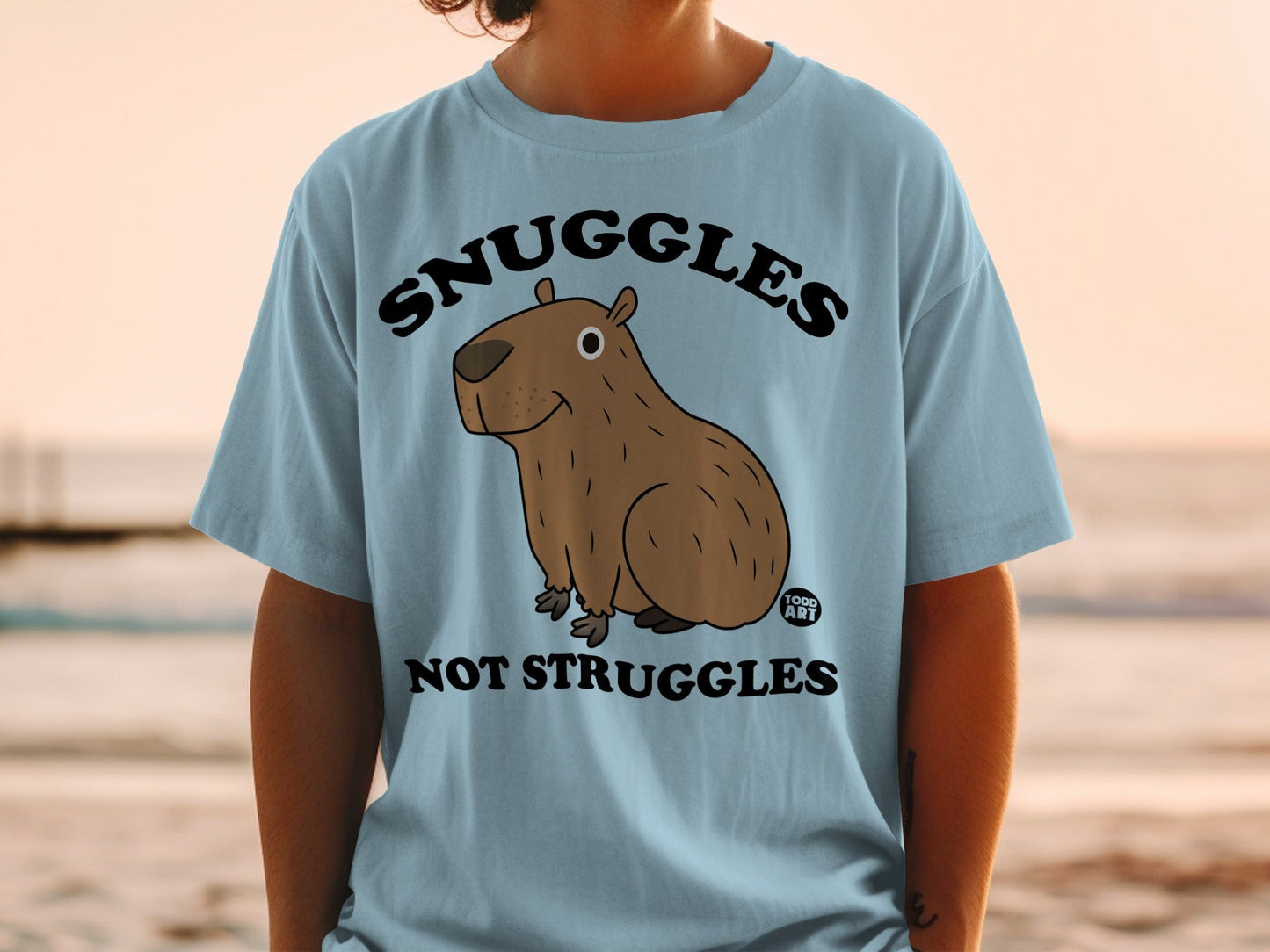 Snuggles Not Struggles Capybara Graphic Tee Product