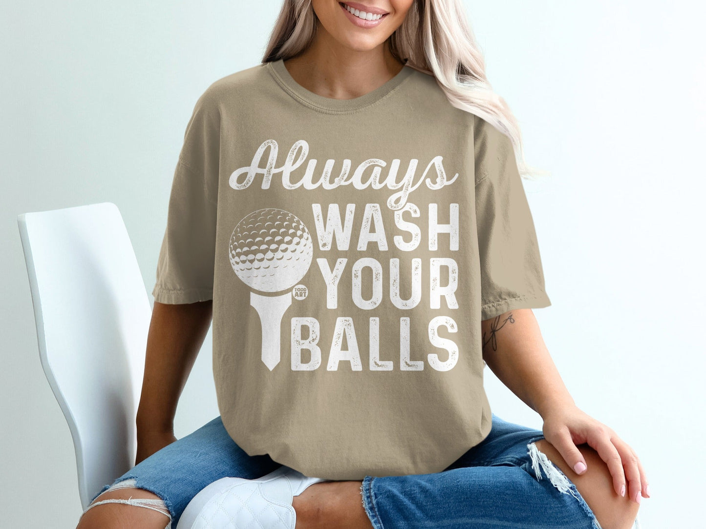 Light brown t-shirt with "Always Wash Your Balls" and a golf ball on a tee graphic.