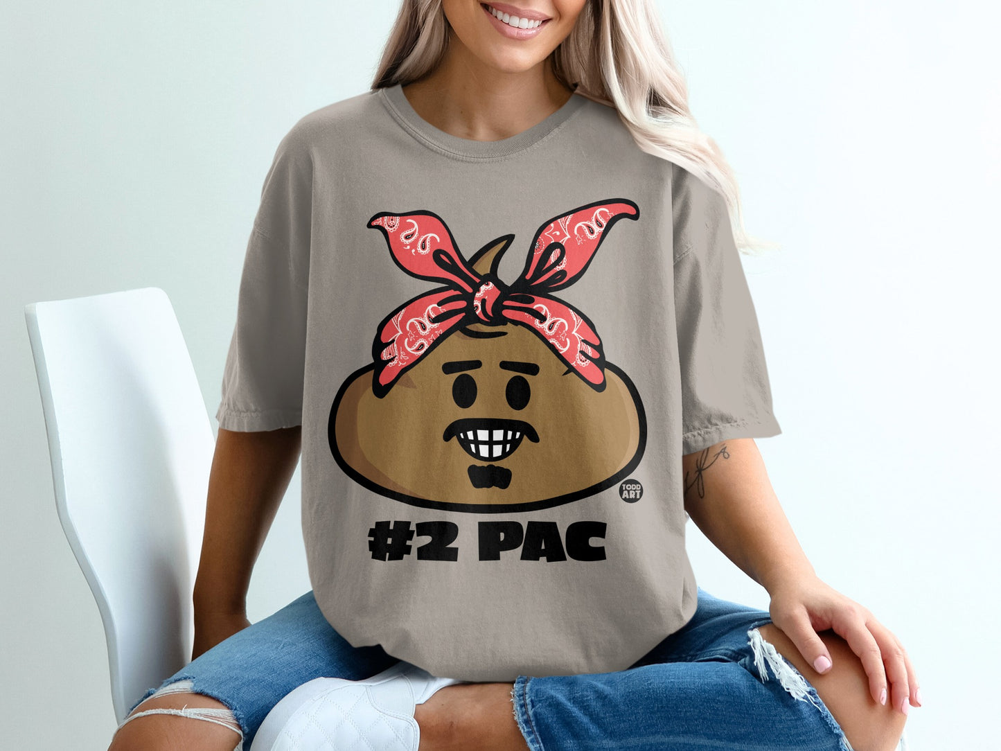 T-shirt with #2 Pac cartoon graphic, red bandana, and distressed jeans.