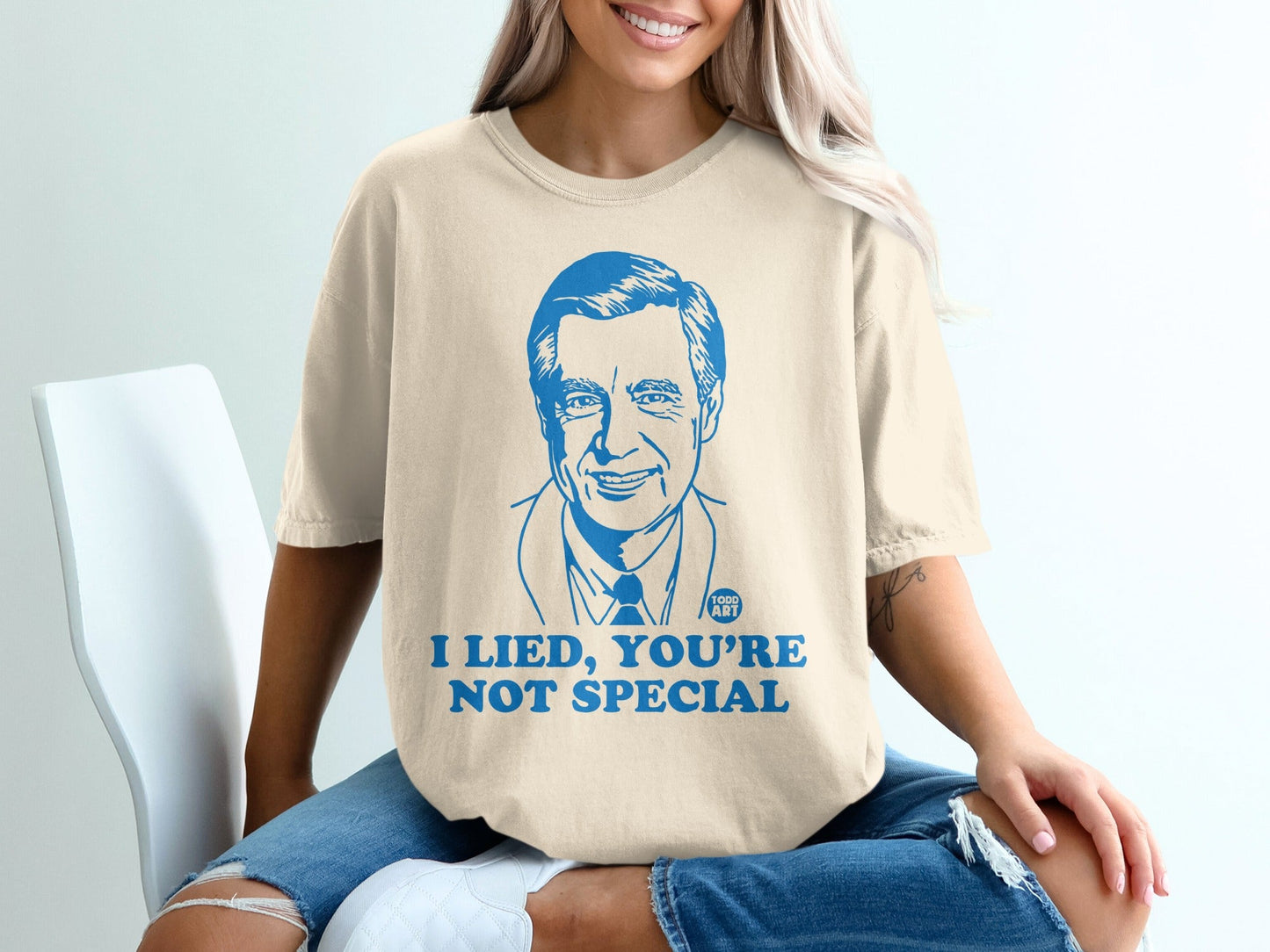 T-shirt with blue graphic of Mr. Rogers saying "I lied, you're not special."