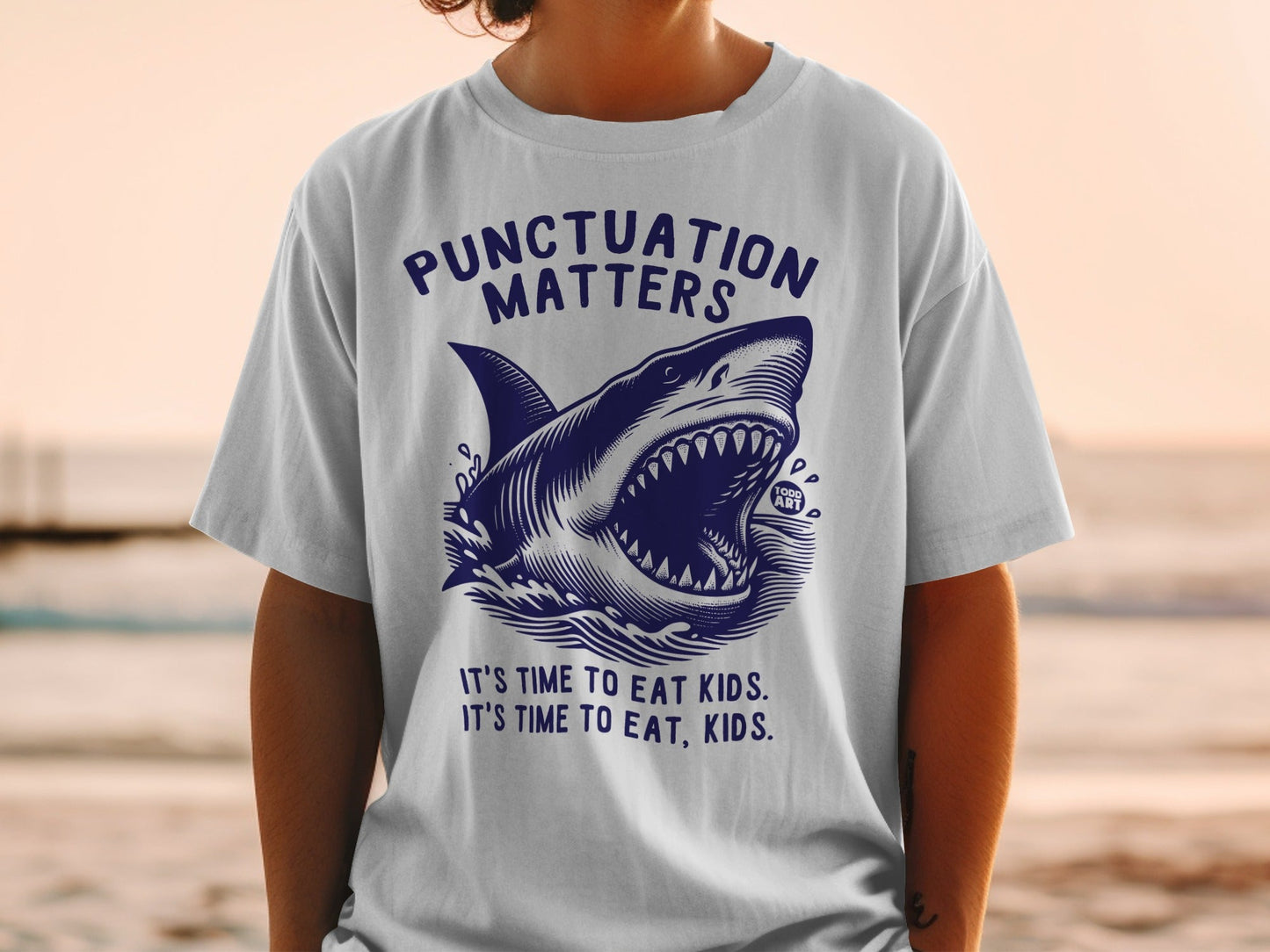 T-shirt with shark graphic and "Punctuation Matters" text.