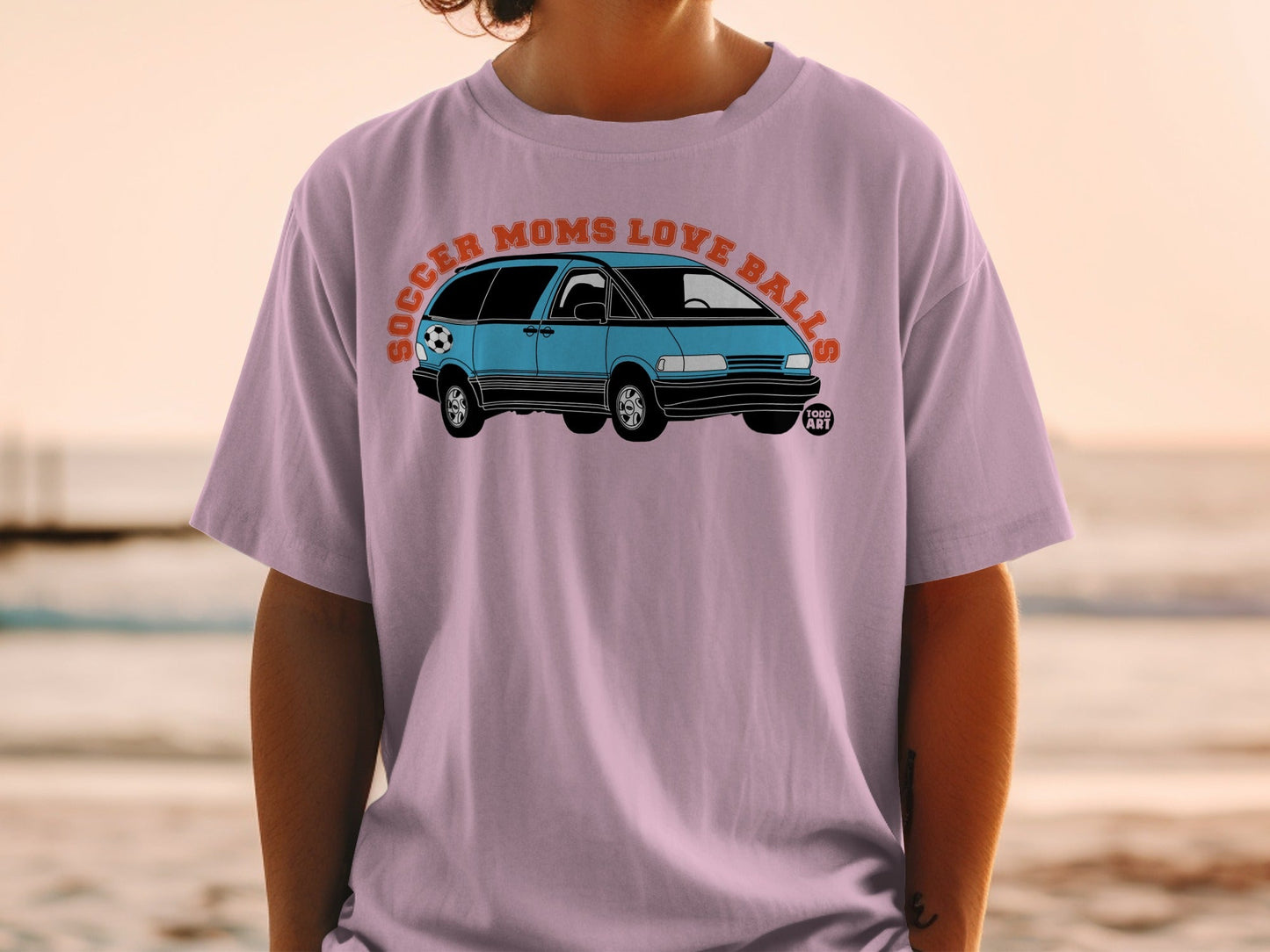 Light purple t-shirt with cartoon minivan and "Soccer Moms Love Balls" text.
