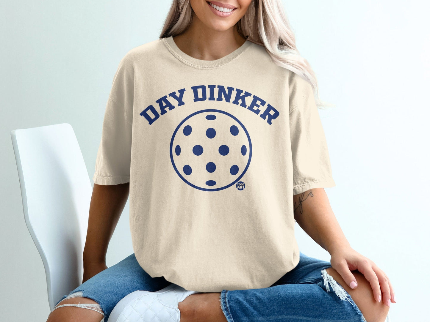 Cream t-shirt with "DAY DINKER" and pickleball graphic.