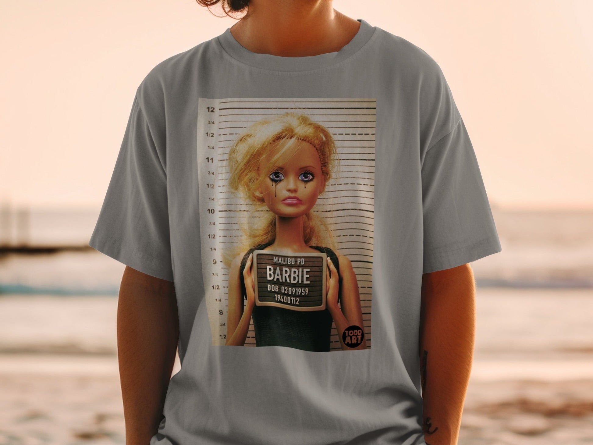 Barbie mugshot t-shirt with "MALIBU PD" and DOB 03091959.