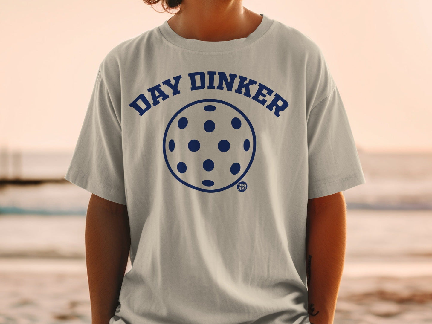 Gray t-shirt with "DAY DINKER" and pickleball graphic.