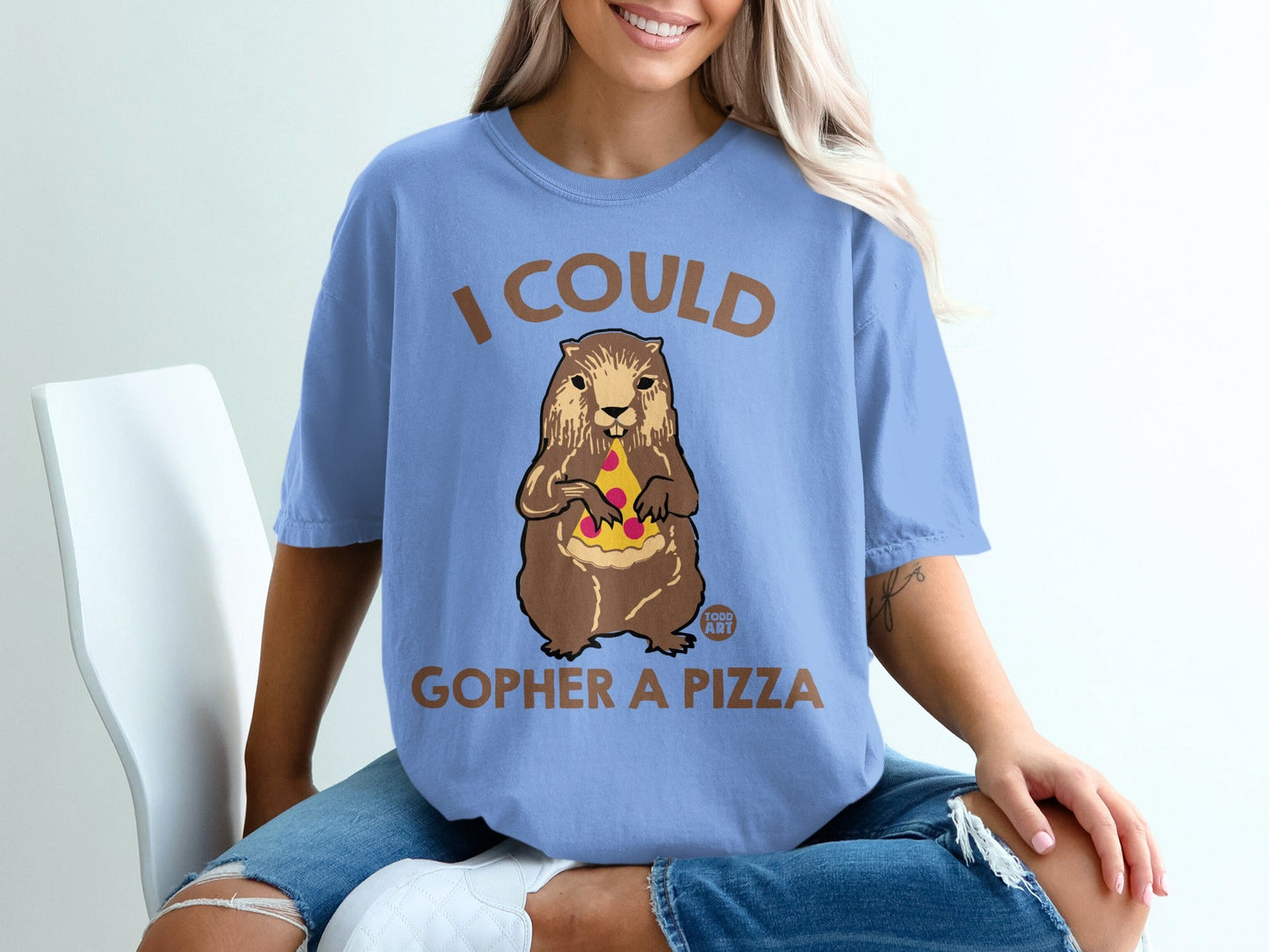 Groundhog holding pizza slices on a blue t-shirt with "I COULD GOPHER A PIZZA" text.