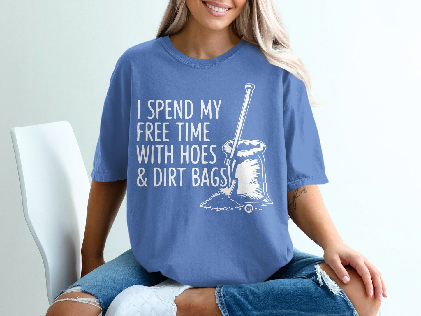 White graphic on a blue t-shirt reading "I spend my free time with hoes & dirt bags."
