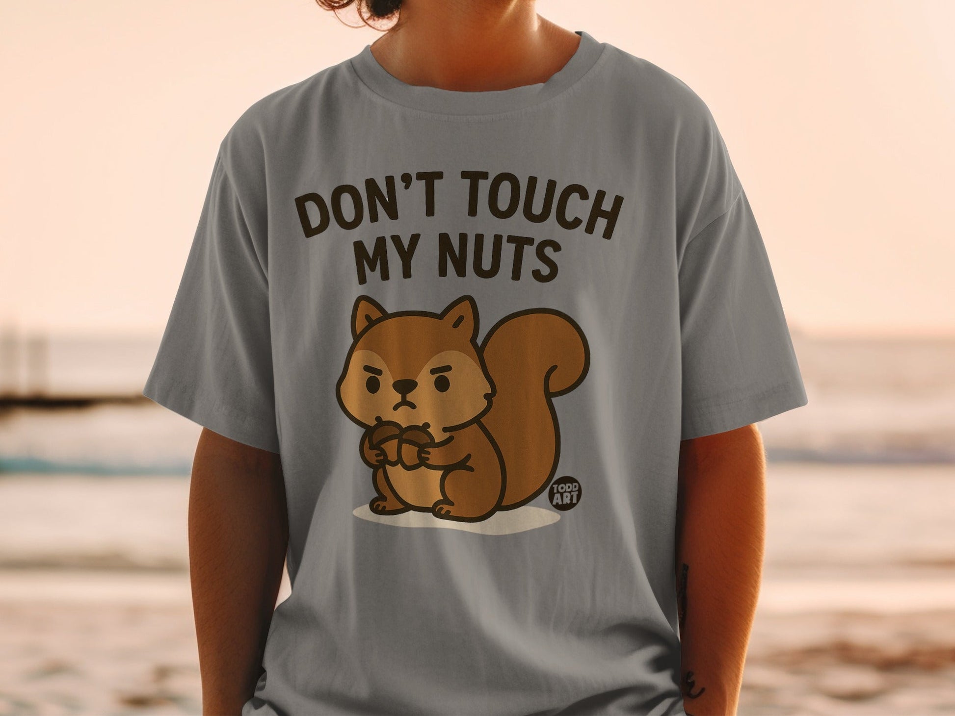 Gray t-shirt with a cartoon squirrel holding acorns and text "Don't Touch My Nuts".