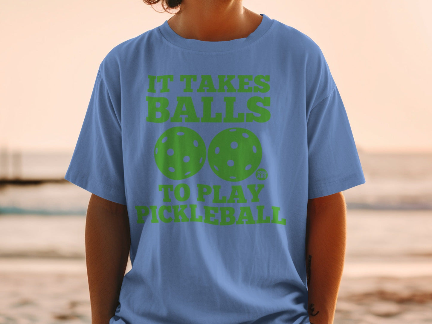 Blue t-shirt with "IT TAKES BALLS TO PLAY PICKLEBALL" and pickleball graphic.