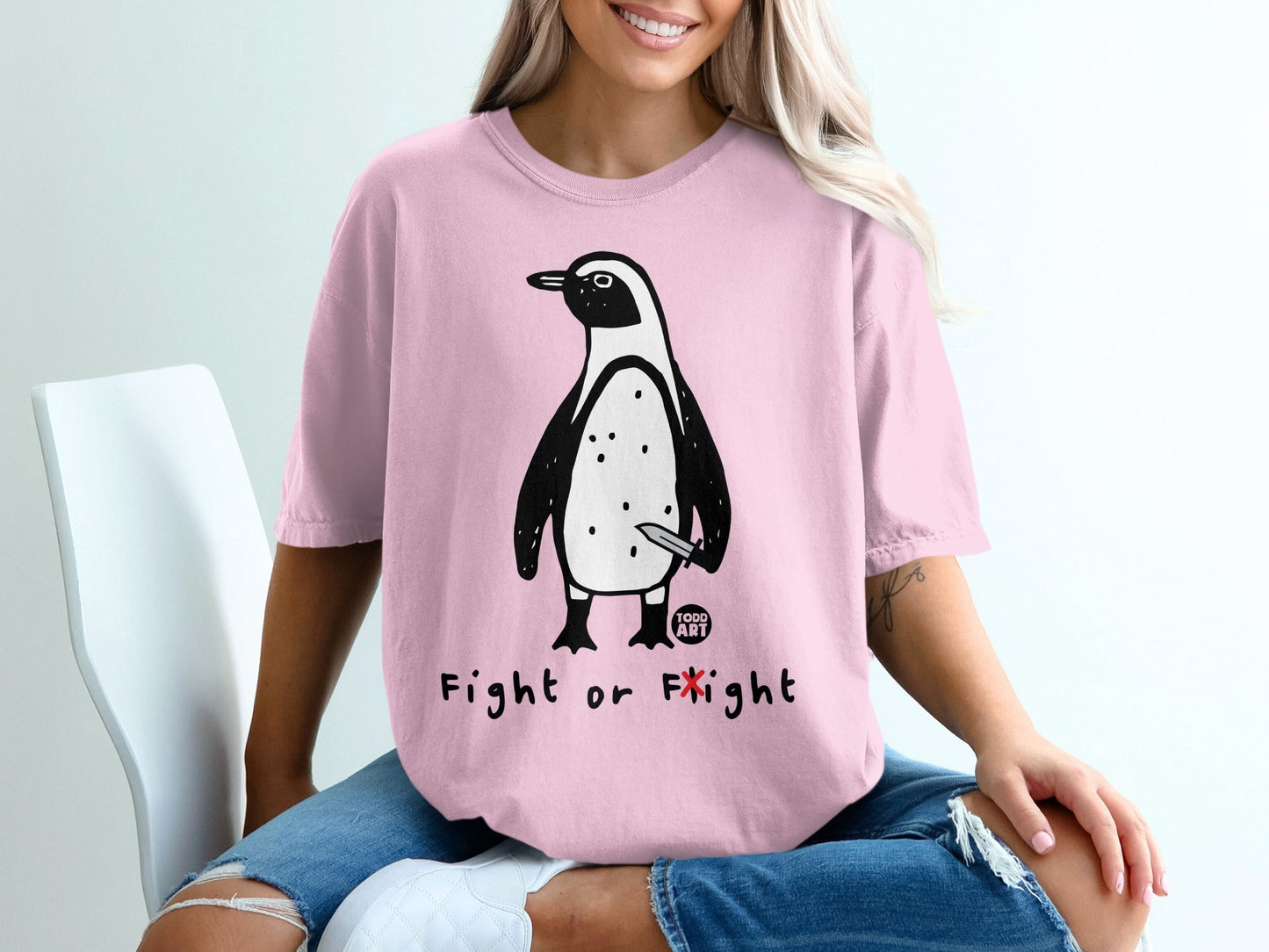 Pink t-shirt with penguin holding a knife, "Fight or Flight" text.