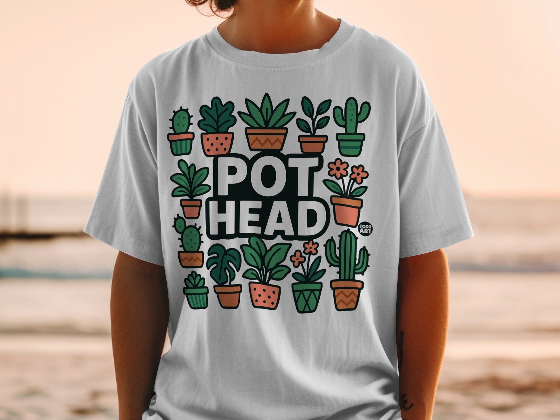 White t-shirt featuring a collection of cartoon potted plants and the text "POT HEAD".