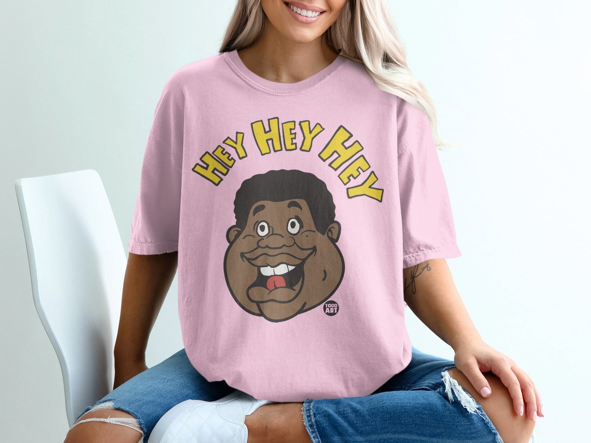 Pink t-shirt with cartoon face and "HEY HEY HEY" text.