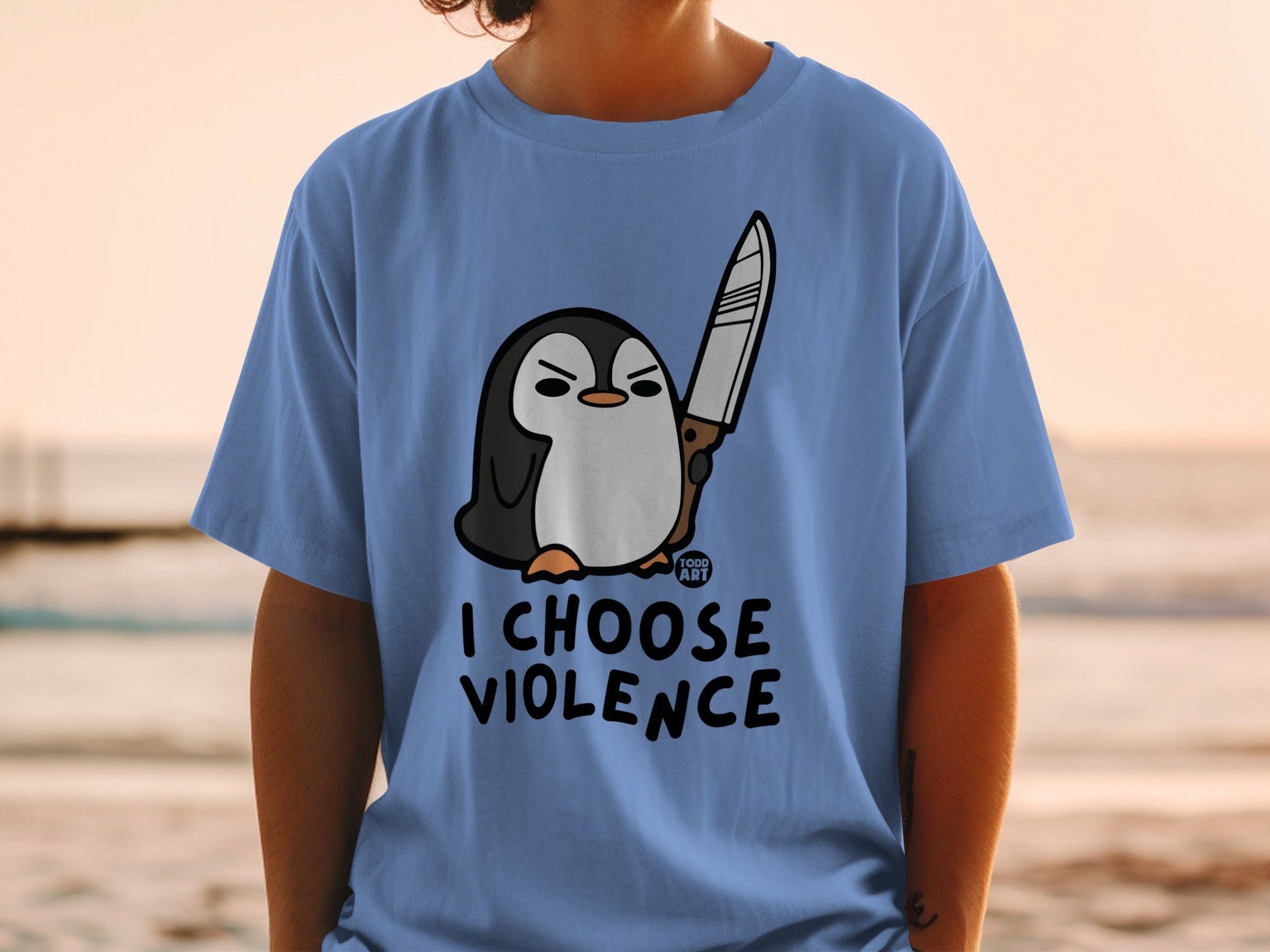 T-shirt with a cartoon penguin holding a knife and the text "I CHOOSE VIOLENCE".