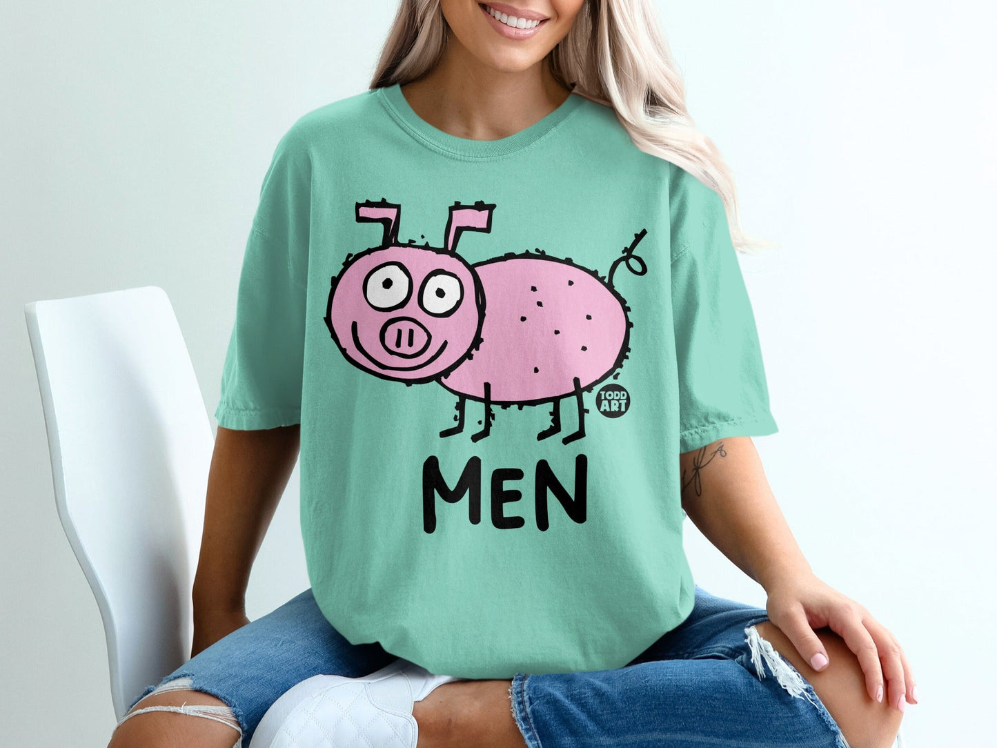 Mint green t-shirt with cartoon pig and "MEN" text.