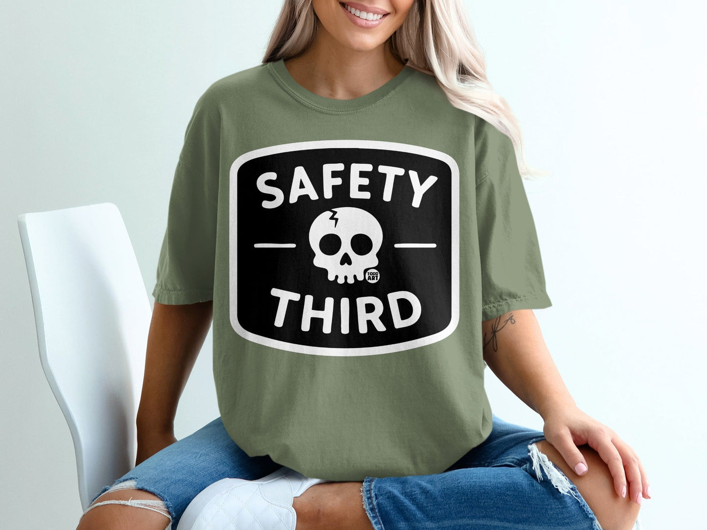 Green t-shirt with "SAFETY THIRD" and a skull logo.