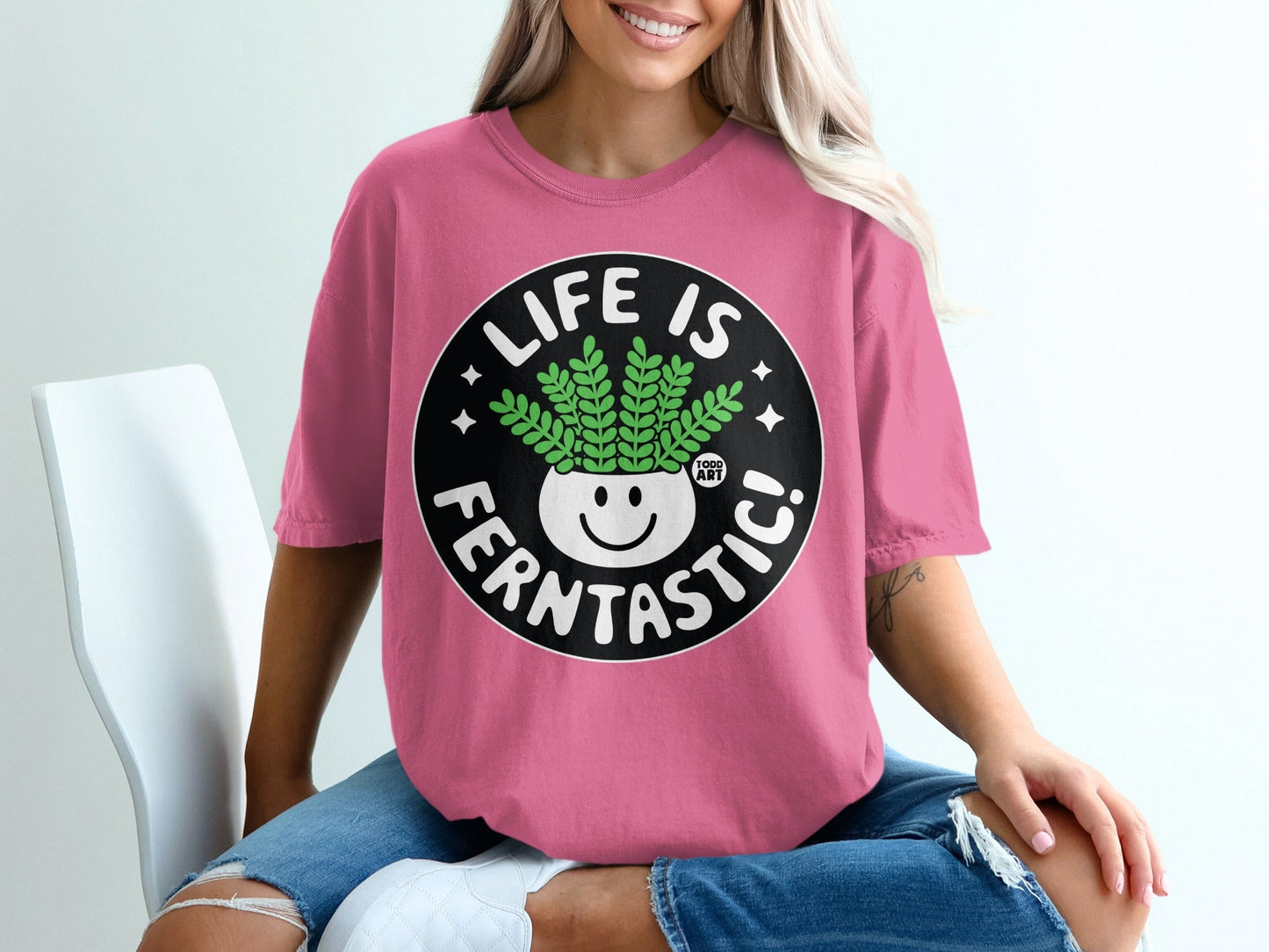 Pink t-shirt with "LIFE IS FERNTTASTIC!" and a smiling plant graphic.