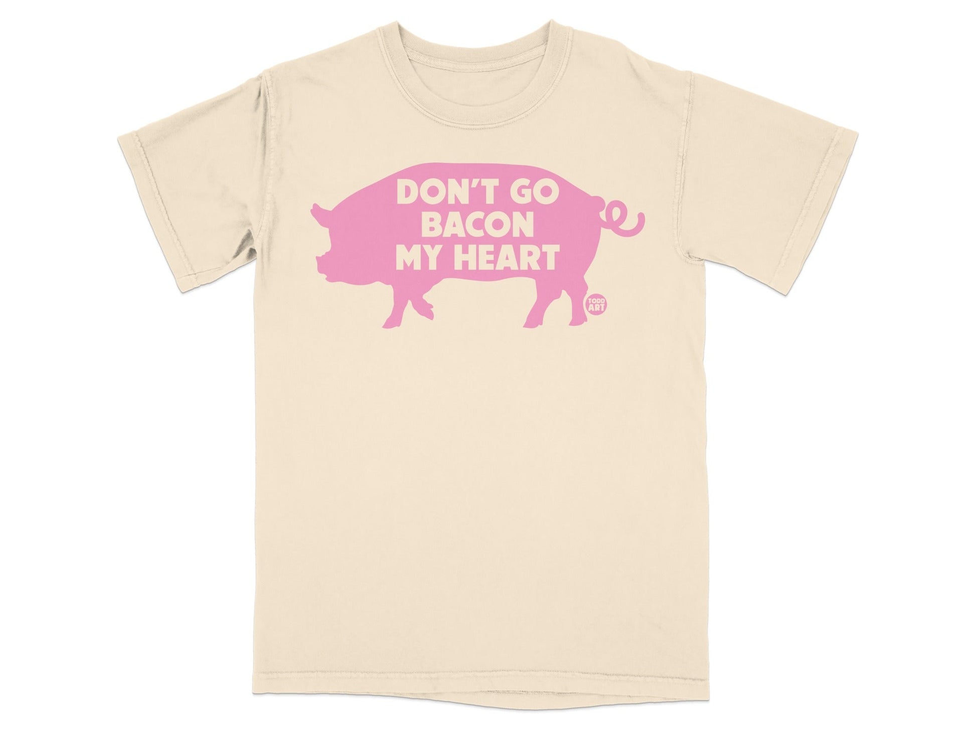 Cream t-shirt with a pink pig silhouette and text "DON'T GO BACON MY HEART".