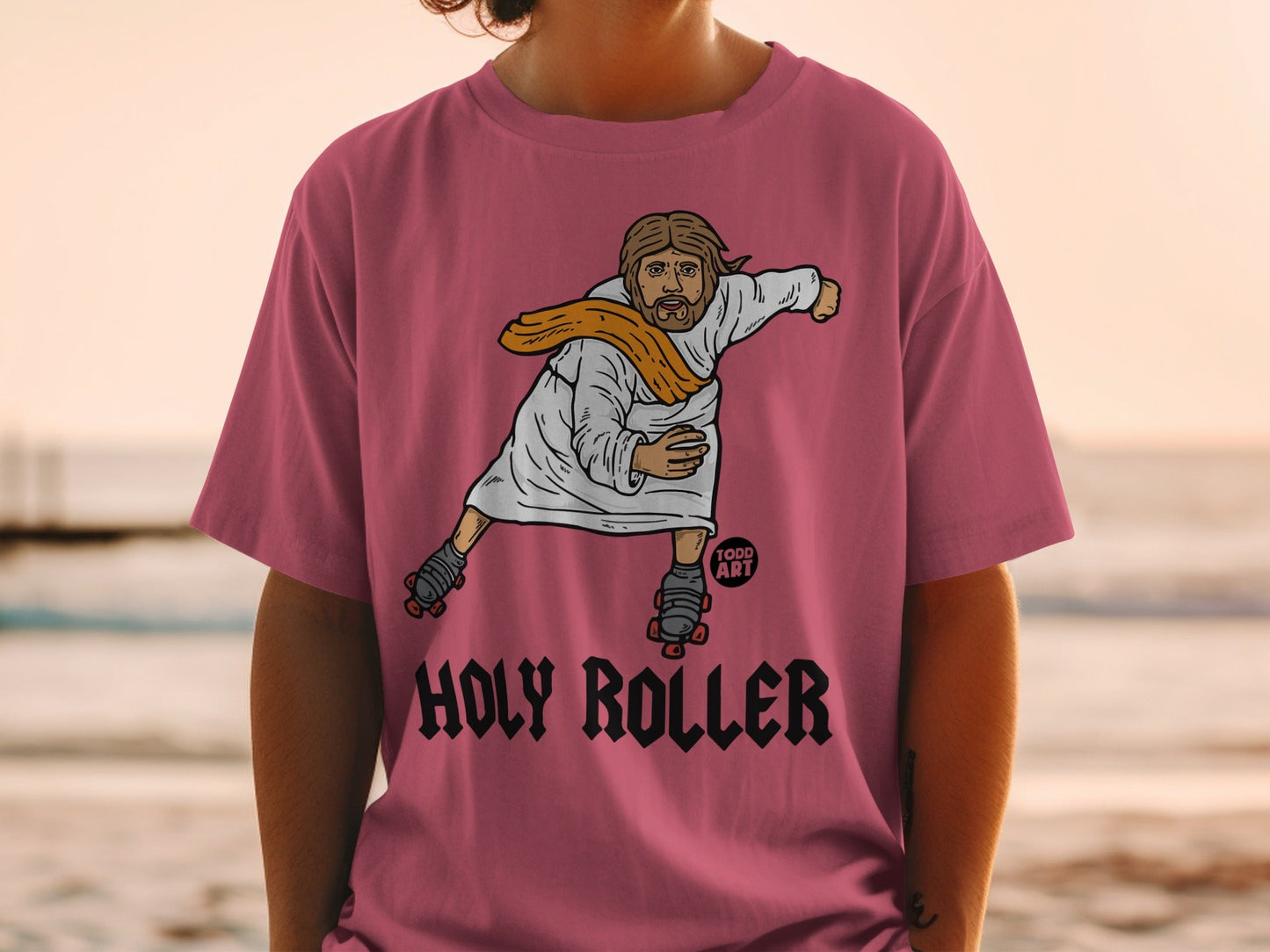Jesus on roller skates wearing a pink t-shirt with "Holy Roller" text.