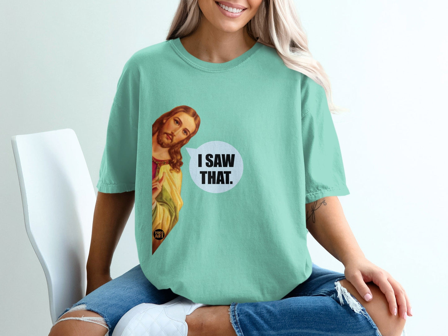 Mint green t-shirt with Jesus graphic and "I Saw That." speech bubble.