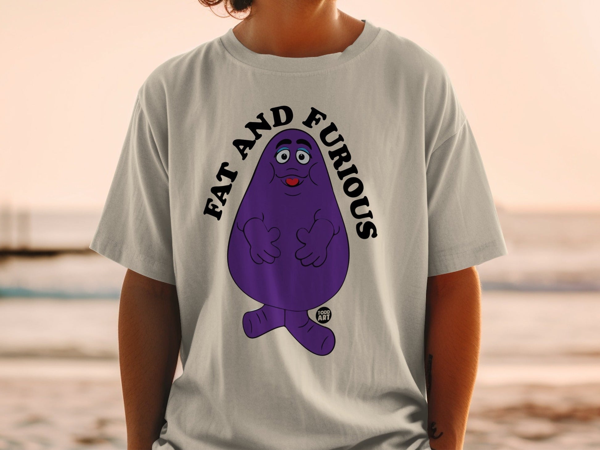 Purple Grimace character on t-shirt with text "FAT AND FURIOUS".