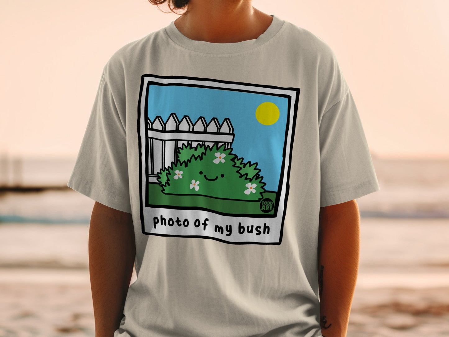 T-shirt with cartoon bush and "photo of my bush" text.