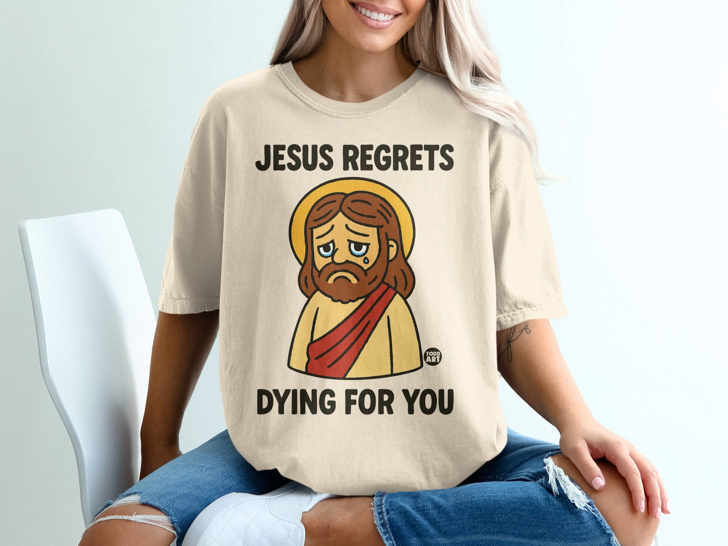 T-shirt with "Jesus regrets dying for you" and crying Jesus graphic.