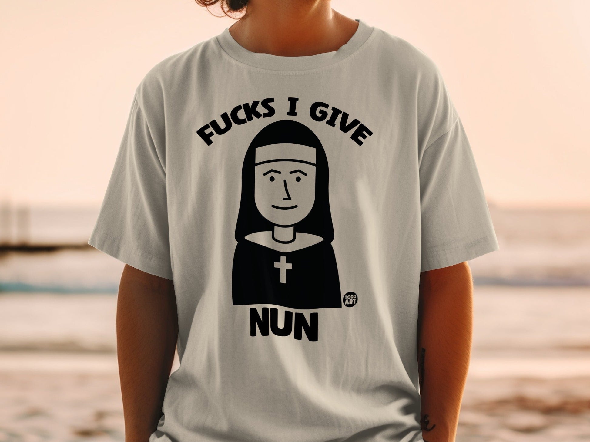 T-shirt with "Fucks I Give Nun" graphic featuring a nun illustration.