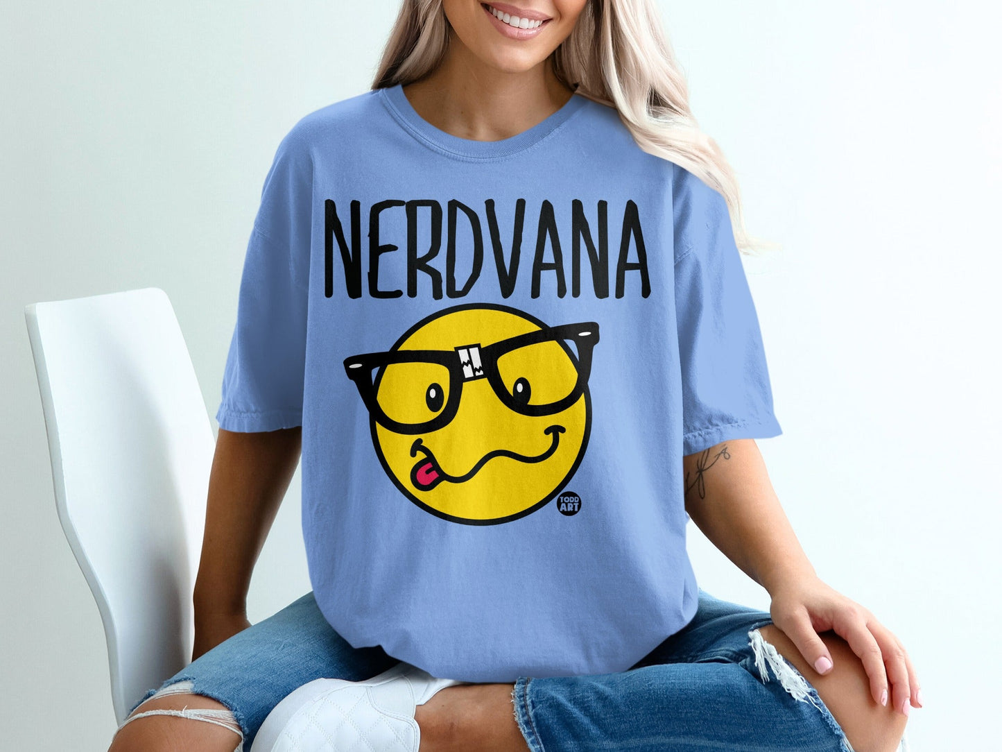 Nerdvana t-shirt with smiling emoji wearing glasses and sticking out its tongue.