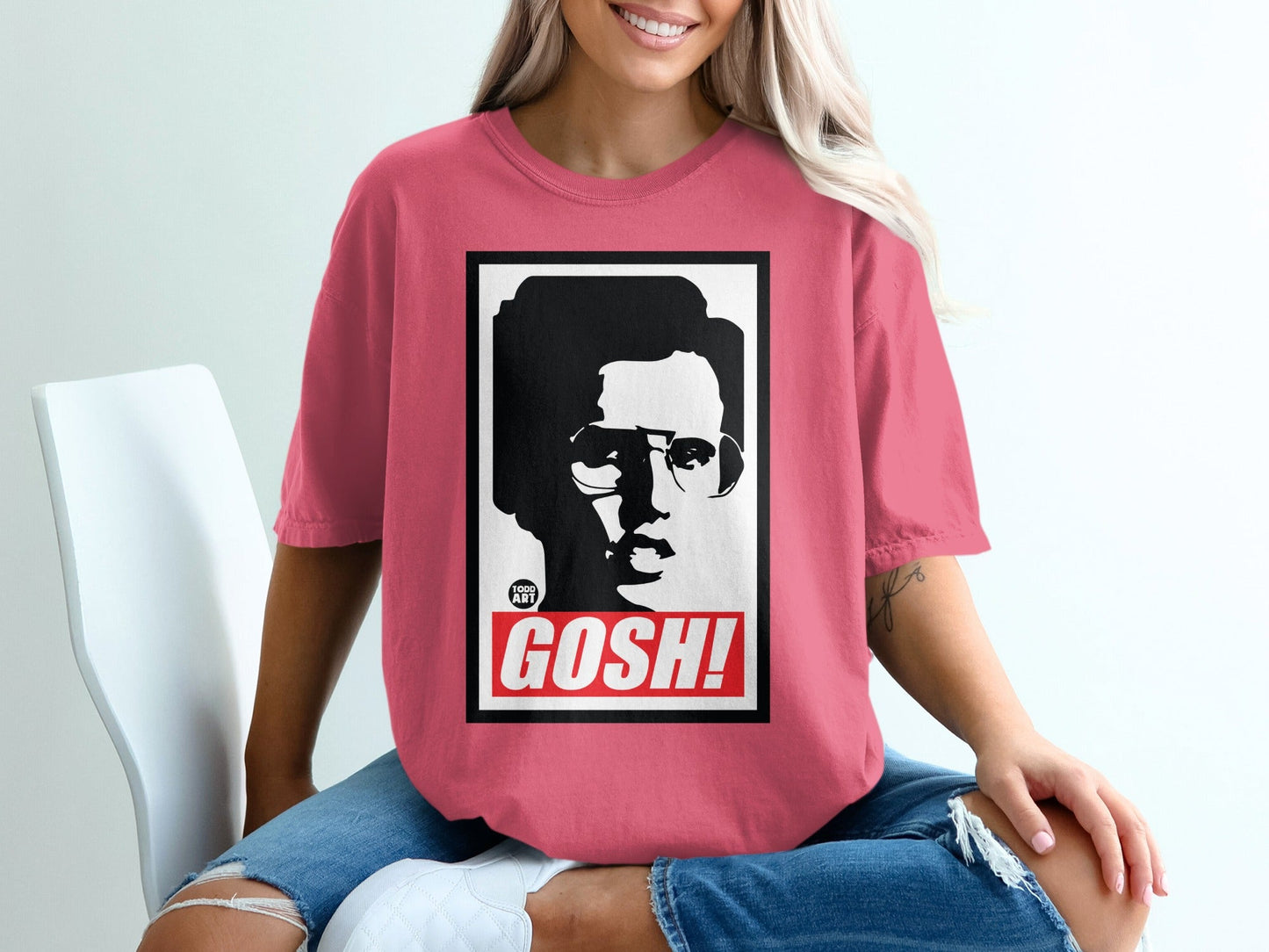 Pink t-shirt featuring black and white portrait with "GOSH!" text.