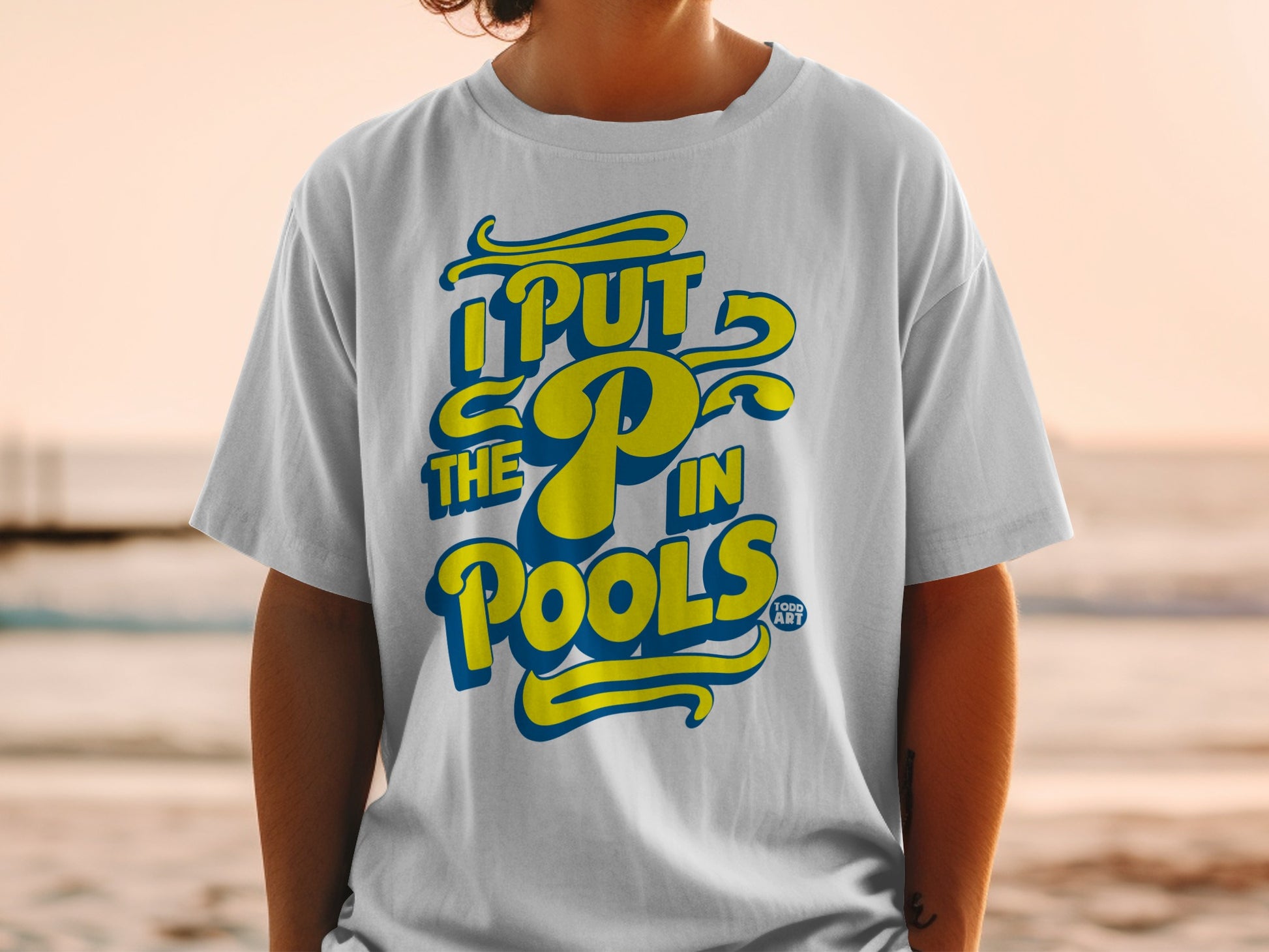 White t-shirt with yellow and blue text that reads "I PUT THE P IN POOLS."