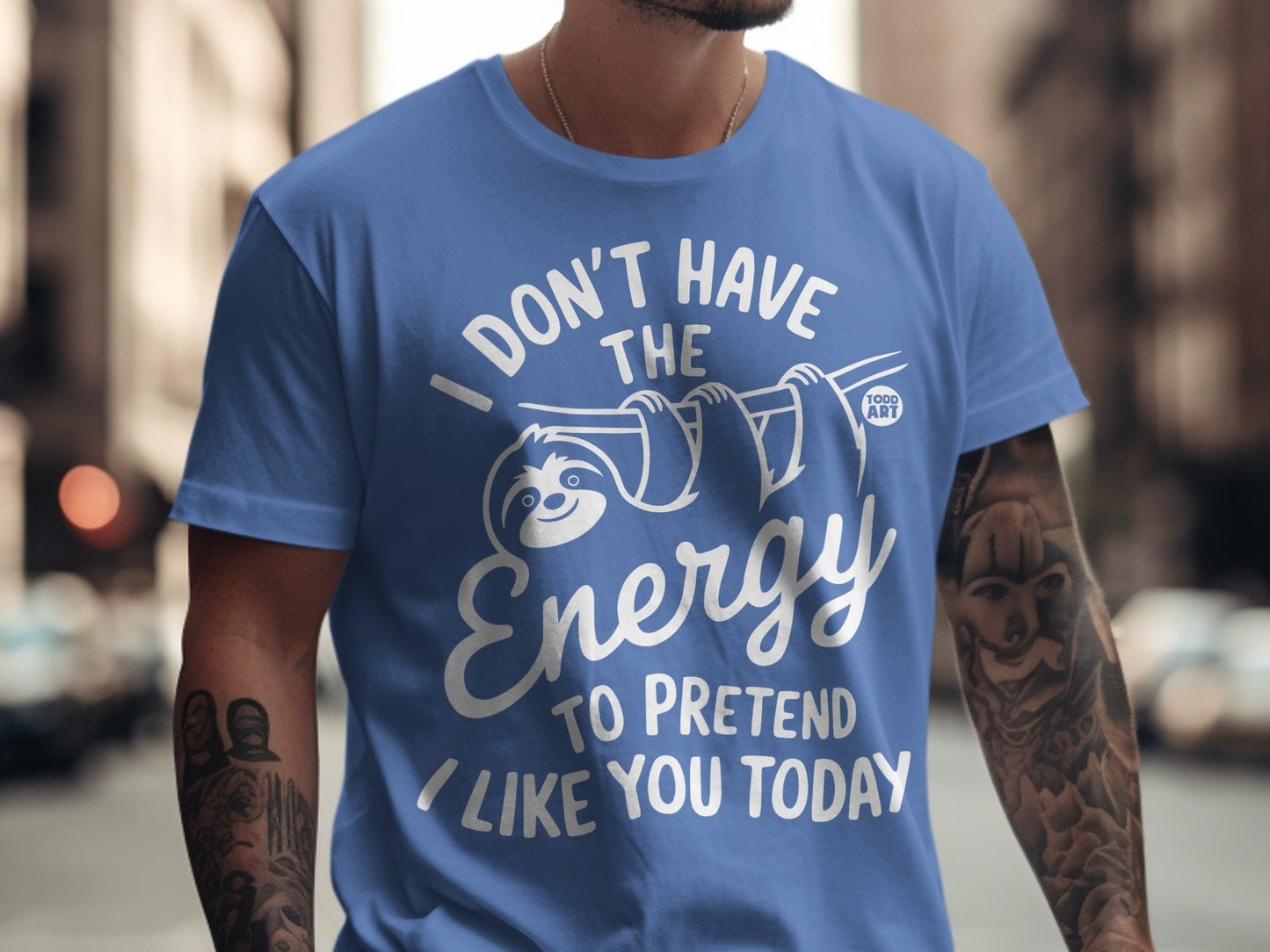 Blue t-shirt with "I don't have the energy to pretend I like you today" slogan and sloth graphic.