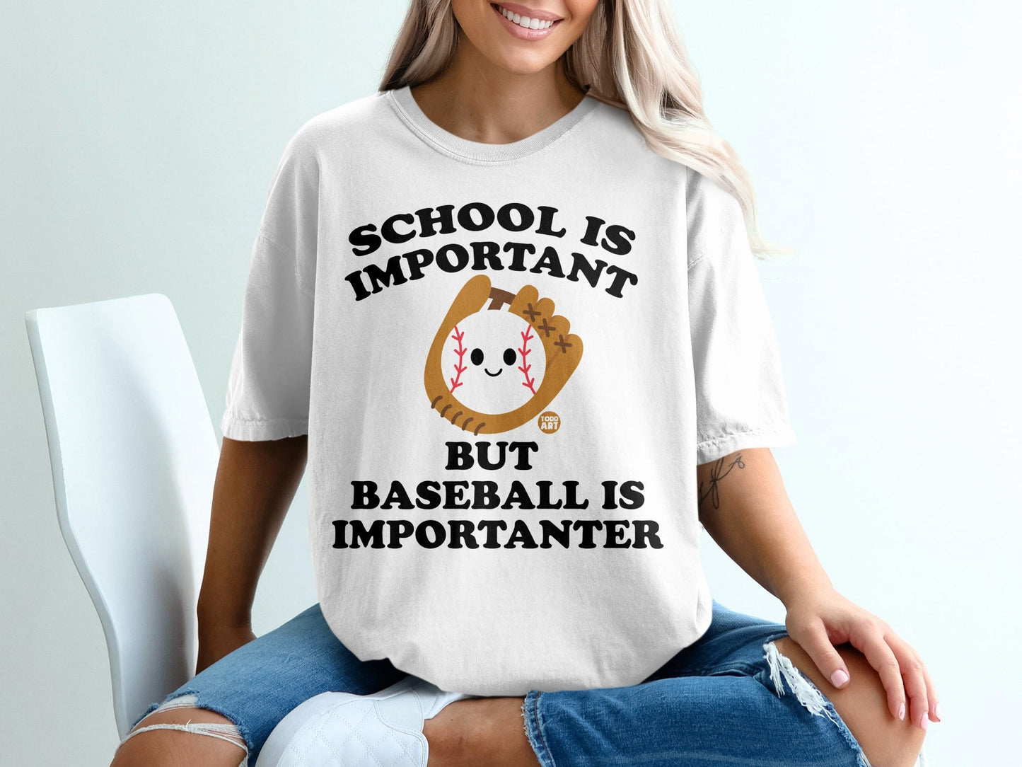 White t-shirt with "School is Important but Baseball is Importanter" text and baseball graphic.