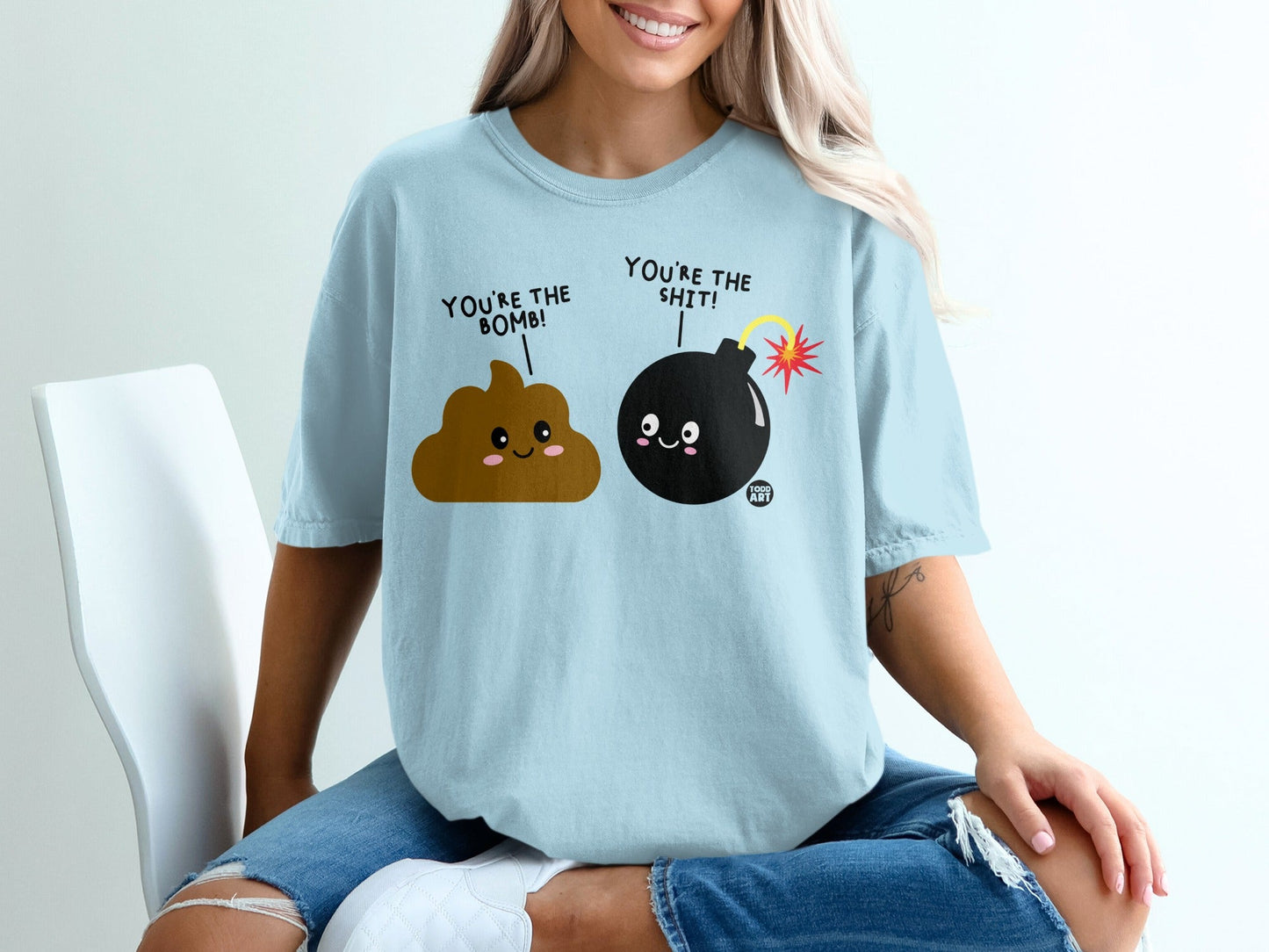 Light blue t-shirt with cartoon poop and bomb characters.